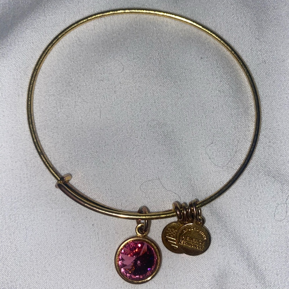 Shiny Gold Alex and Ani bangle bracelet with October birthstone.
